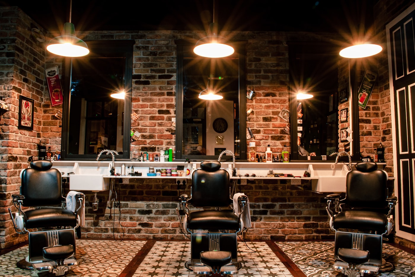The three chairs and the mirror along the wall of the shop